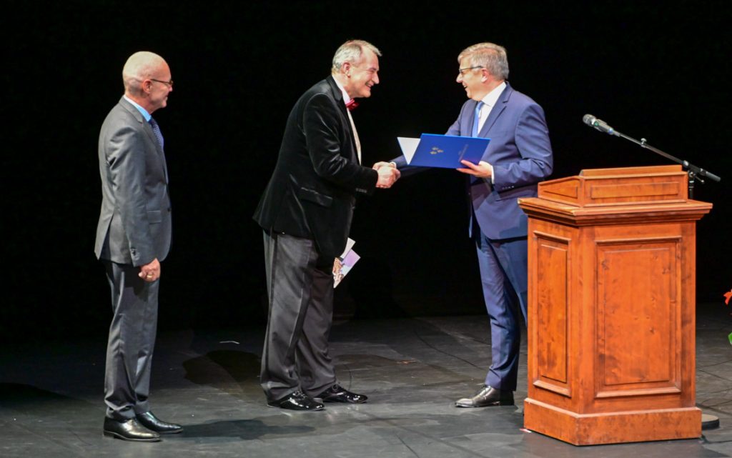 Gert-Uwe Mende übergibt die Urkunde zur Stadtplakette an Uwe-Eric Laufenberg.