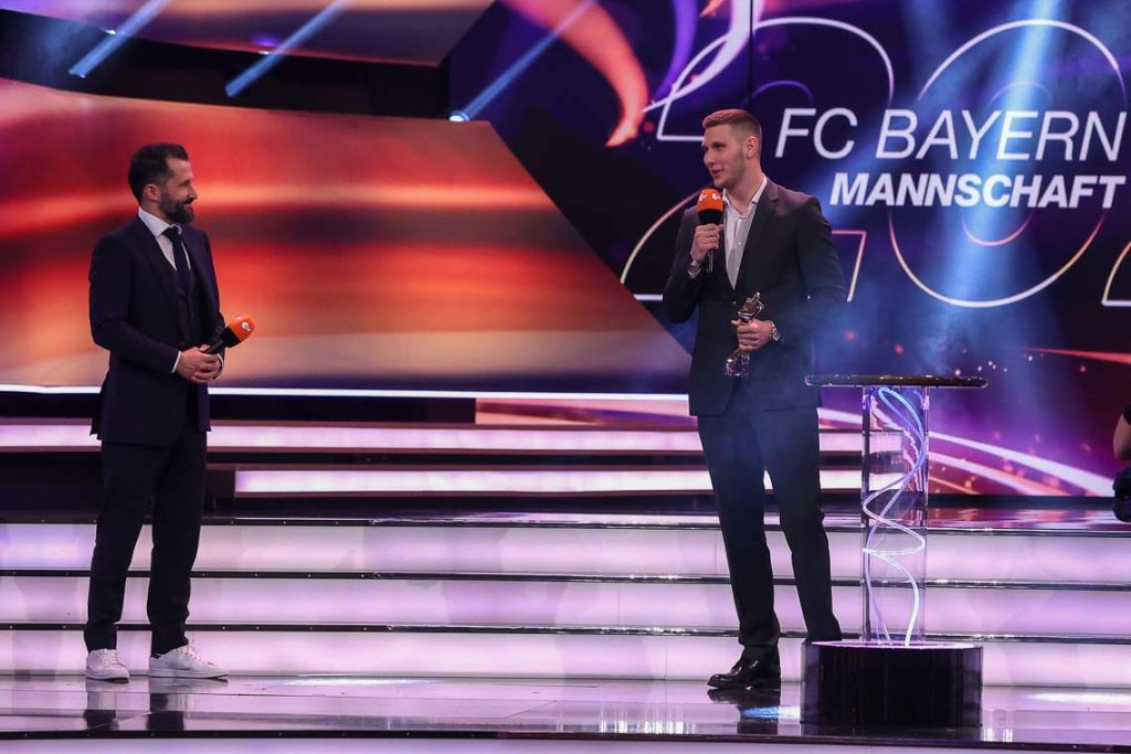 Niklas Süle of FC Bayern München receives with team manager Hasan Salihamidzic (L) the "Team of the Year" award during the "Sportler des Jahres" Gala (German athlete of the year) at Kurhaus Baden-Baden on December 20, 2020 in Baden-Baden, Germany. (Photo by Alexander Hassenstein/Getty Images)