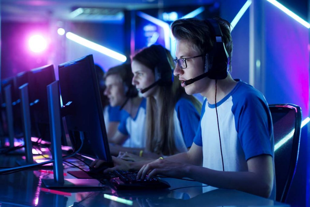Team of Teenage Gamers Play in Multiplayer PC Video Game on a eSport Tournament.