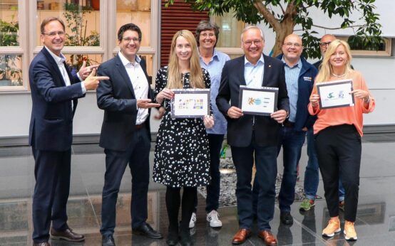 Nach getaner Arbeit: Die Wasserglas-Jury mit (v. l.) Frank Rolle (ESWE Versorgung), Olaf Streubig (Journalist), Sina Schreiner (Journalistin) mit dem zweiten Platz, Anke Auen (ESWE Versorgung), Ralf Schodlok (Vorstandsvorsitzender ESWE Versorgungs AG) mit dem Gewinner-Motiv, Robert Hammann (ESWE Versorgung), Maik Schmiele (ESWE Versorgung) und Sabine Stang (Mediengestalterin) mit dem Drittplatzierten.