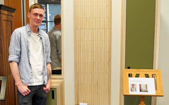 Patric Jonah Schmidt mit seinem Meisterstück, dem Garderobenmöbel „Silva“ aus geölter Esche und Schichtstoff.