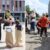 Spielende Kinder auf der Straße: Kästchenspringen und Sackhüpfen.